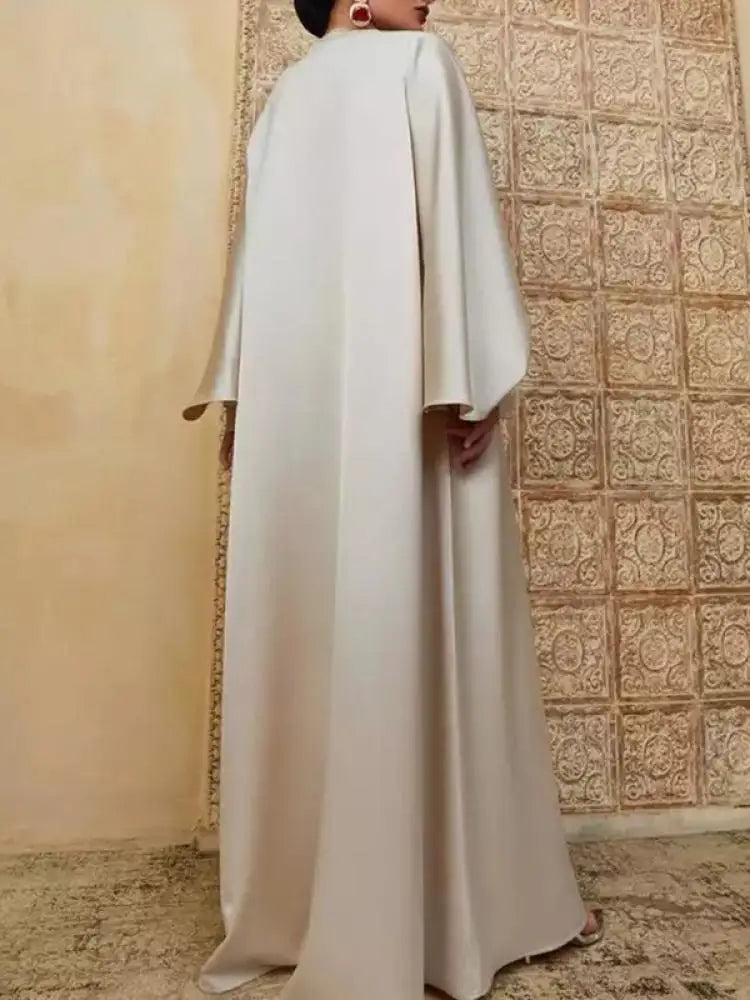 Elevate your modest wardrobe with this elegant floor-length abaya, designed for comfort and effortless style. Featuring a flattering round neckline, long batwing sleeves, and a loose, flowing silhouette, this solid-color robe offers full coverage