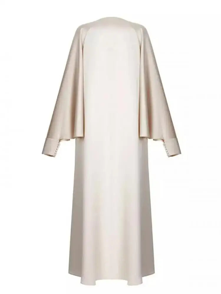 Elevate your modest wardrobe with this elegant floor-length abaya, designed for comfort and effortless style. Featuring a flattering round neckline, long batwing sleeves, and a loose, flowing silhouette, this solid-color robe offers full coverage