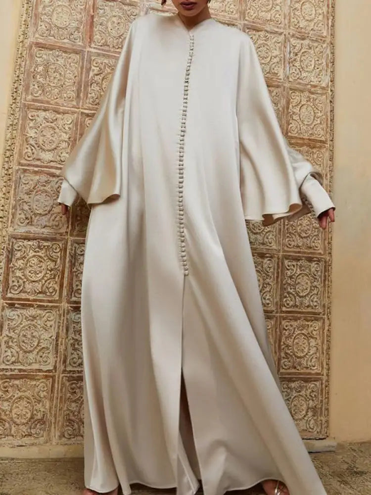 Elevate your modest wardrobe with this elegant floor-length abaya, designed for comfort and effortless style. Featuring a flattering round neckline, long batwing sleeves, and a loose, flowing silhouette, this solid-color robe offers full coverage