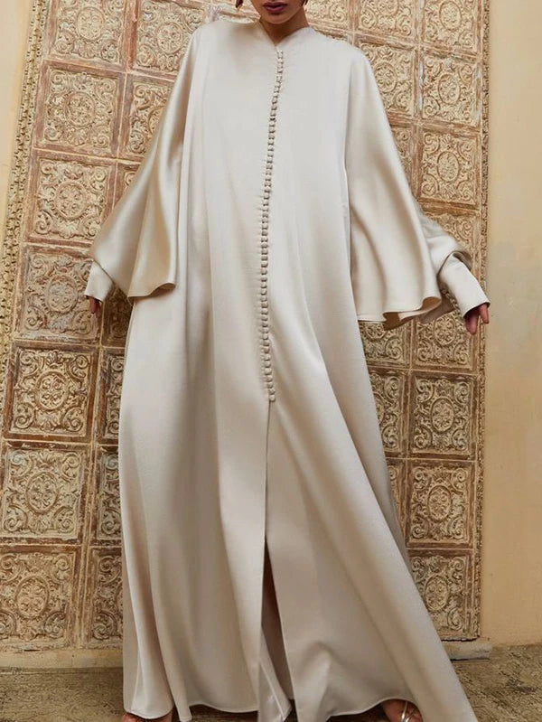 Elevate your modest wardrobe with this elegant floor-length abaya, designed for comfort and effortless style. Featuring a flattering round neckline, long batwing sleeves, and a loose, flowing silhouette, this solid-color robe offers full coverage